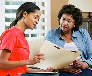 Hospice Patient Reviewing Care With Nurse 