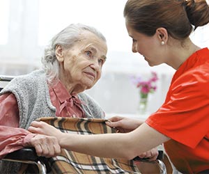 Senior being blanketed by Bayada Nurse