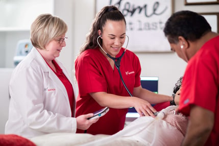 Photo of two RNs and one Clinical Manager training in a Simulation Lab for National Nurses Week