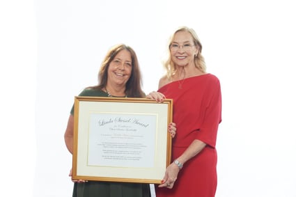 2023 Linda Siessell Award winner Michelle Moran stands with Linda Siessell holding her certificate
