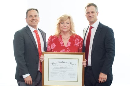 2023 Mary Hockstein Award winner Michelle Cashwell stands, holding her certificate, with Eric Thull and David Baiada