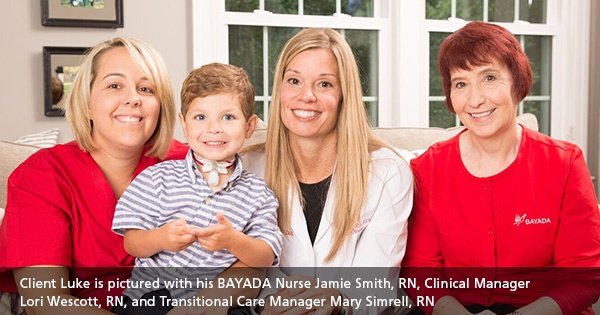 Child client and team of nurses and clinical manager smiling for the camera