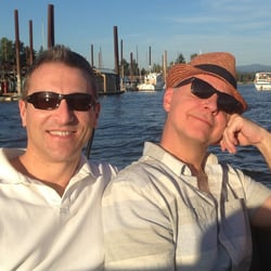 Previous BAYADA client Stephen with husband Neal posing for photo together in a boat