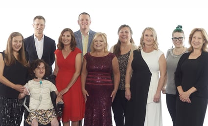 BAYADA PT Hero of the year Michele Puzio stands with David Baiada and her client and family to celebrate her recognition