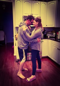 husband and wife dancing in the kitchen