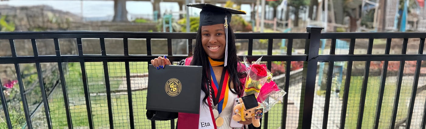 Bria holding her diploma and flowers